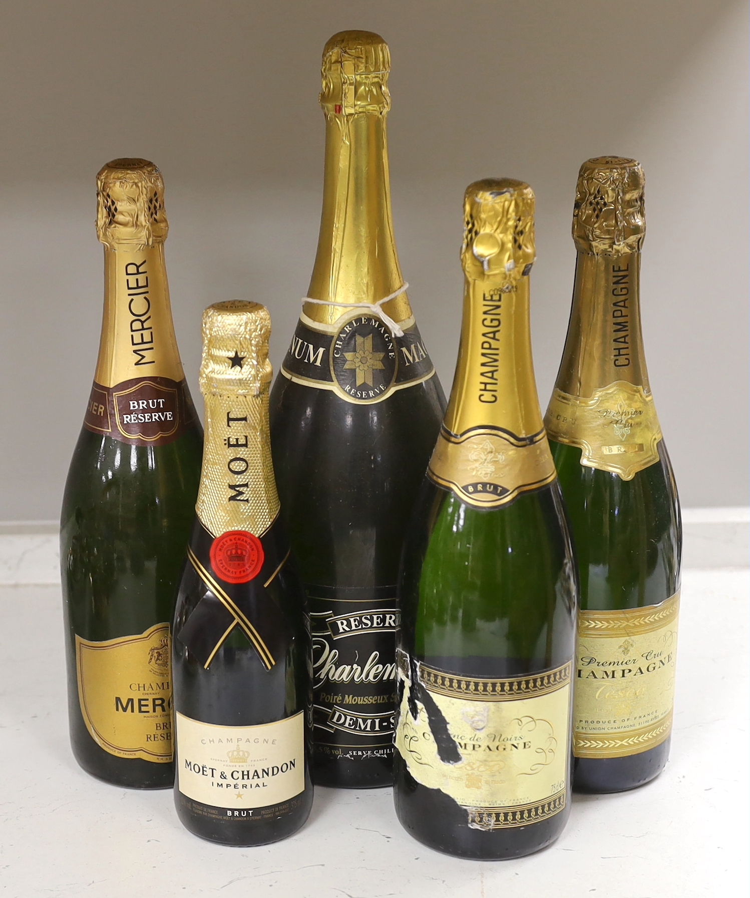 Five bottles of mostly champagne to include a magnum of Charlemagne, a bottle of Mercier, a bottle of Bland De Noirs, a bottle of Premier Cru and a 375ml bottle of Moët & Chandon